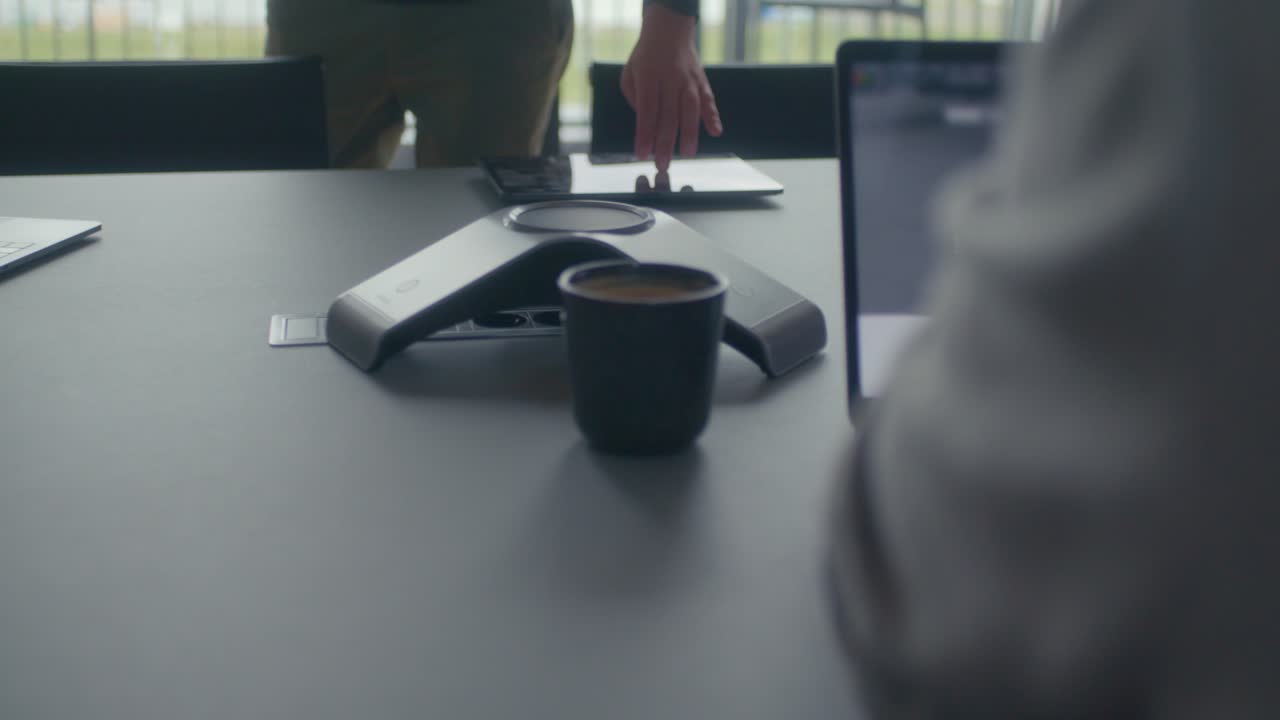 Man wipes fingers across tablet in an office