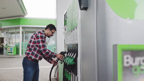 man filling gas at a gas station