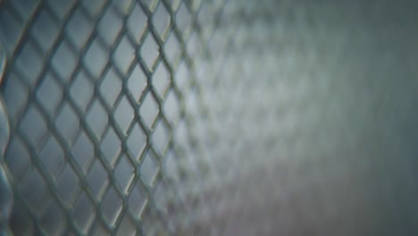 a hyper macro shot of a metal grid, steel pattern, iron industrial texture, aluminum material, super slow motion, full hd 120 fps, tilt up movement