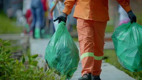 a man carries garbage bags to take for recycling