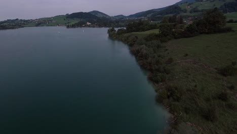 Flight-Next-To-The-Coast-Above-Nature,-Lake-Gruyère,-Switzerland-1