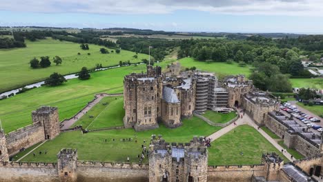 aerial view of alnwick castle, medieval walls and duke residence in green landscape of northumberland, england uk