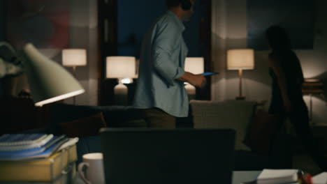 annoying man peeping laptop at evening flat closeup. angry woman going away