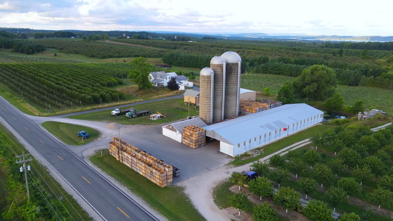 Old silos and farm near countryside road in Michigan, USA, aerial view