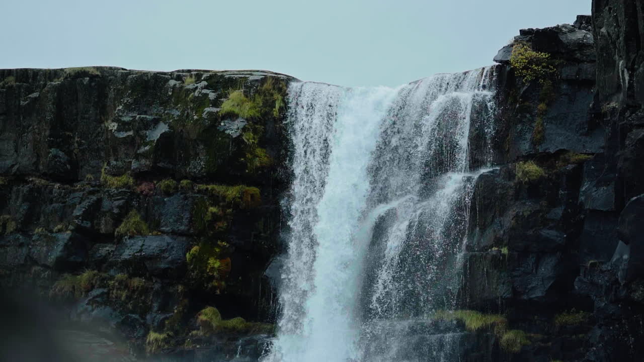 Dramatic Waterfall Cascading Down Rocky Cliffs