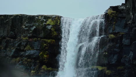 dramatic waterfall cascading down rocky cliffs