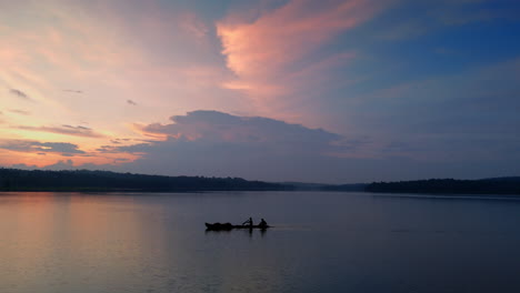 morning calm lake a boat is flowing the surfaces , cloudy morning and lake reflecting the atmospheric effects of the sky