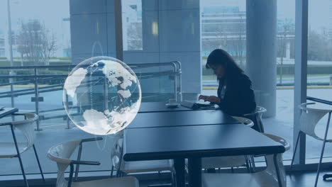 animation of globe over biracial businesswoman using tablet