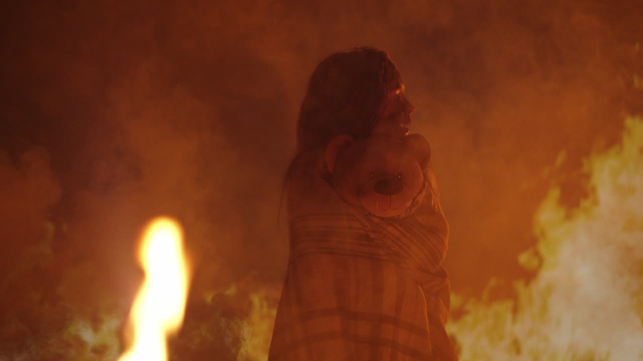Child and Teddy Bear Amidst Blazing Fire