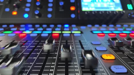 Detail of mixing desk or concole and moving volume faders in slow motion, digital or automatic, no hands or fingers