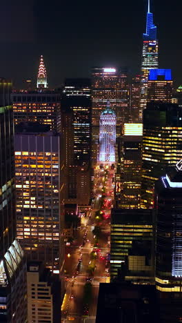 light broad street among the sparkling skyscrapers. fantastic new york panorama at night time. vertical video