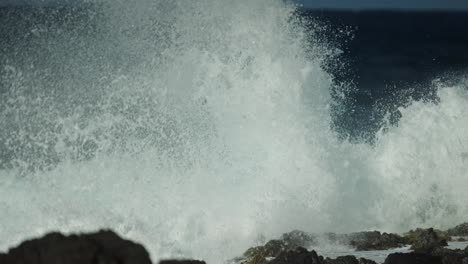 powerful ocean waves crashing on the rocky shore