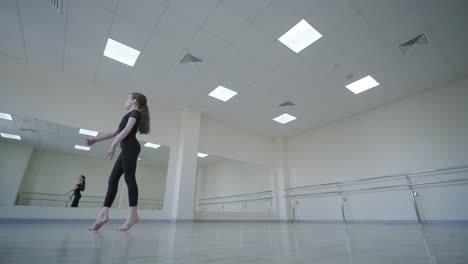 young ballet girl at studio lesson. training performance. stretching exercise pose. ballerina practice balance technique. classical elegance fitness.