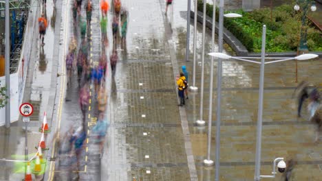 tilt time lapse of marathon runners running through city centre