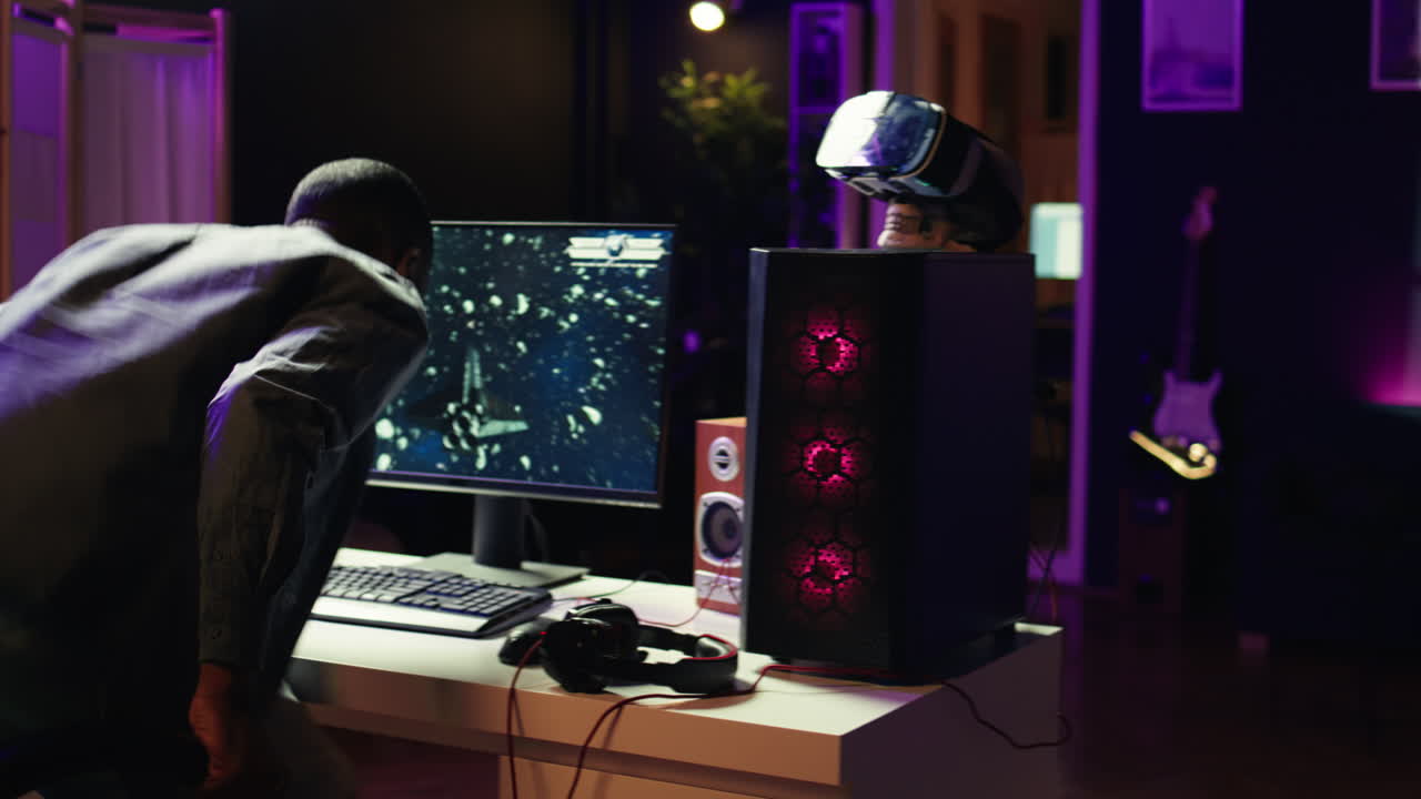 Man coming home to play SF space videogame on PC