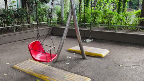 a quiet, nostalgic scene with an empty swing set in a tokyo park on a peaceful afternoon