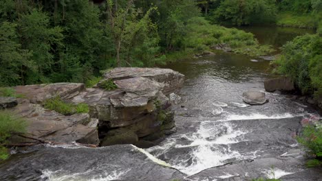 tanner falls in northern pennsylvania as seen from above in the summer time bordered with green trees