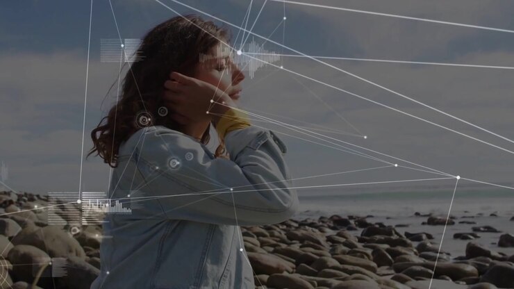 Woman shifting profile at shore as sun hitting eyes causing shielding technology HUD crossing her