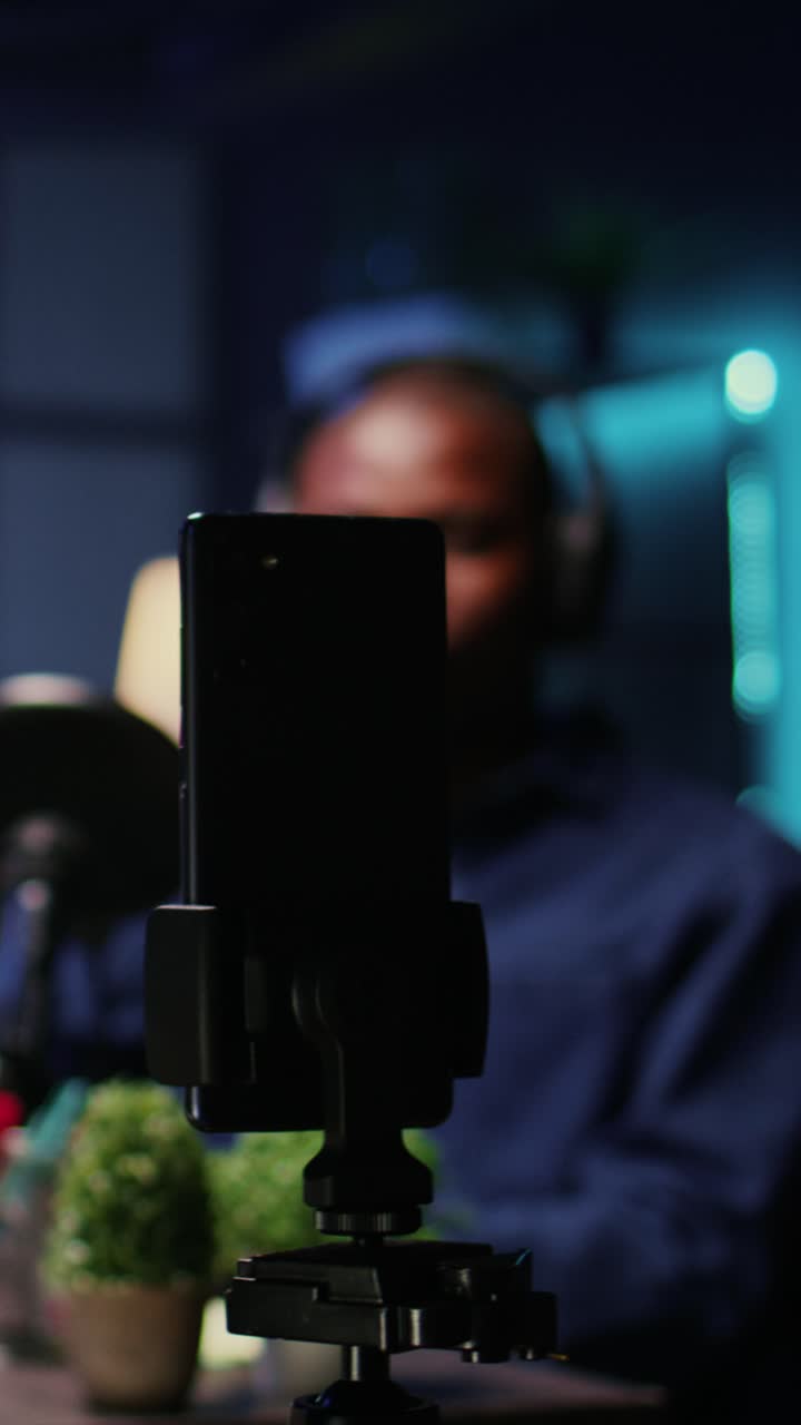 Vertical video Close up shot of mobile phone used to produce comedy podcast