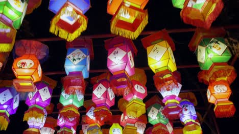 walking under colorful chinese hanging lanterns lit up at night