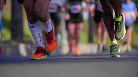 beautiful slow motion on a group of runners from marathon. close view on legs