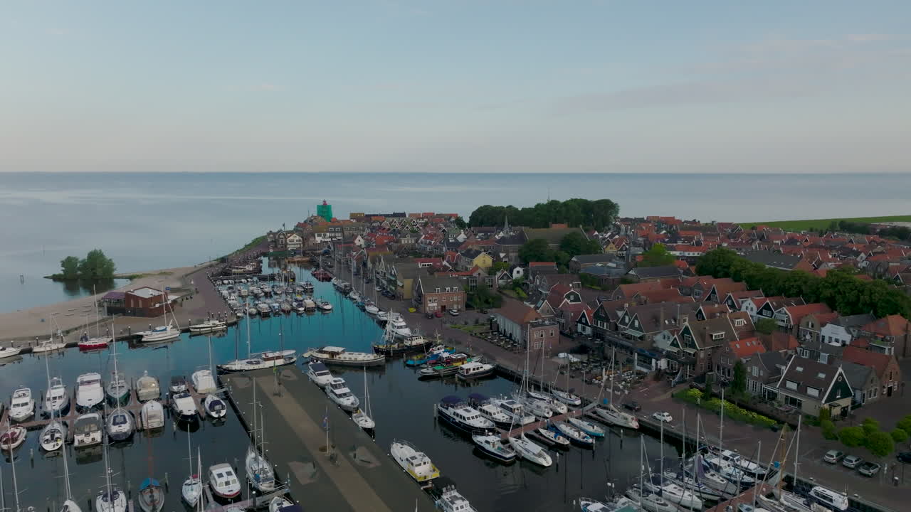 Sail boats and motor boats moored in the harbor of the historic fishing village of Urk in the Netherlands