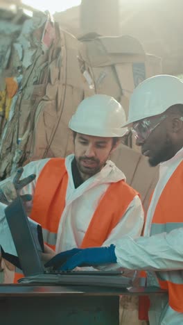 recycling plant workers reviewing data