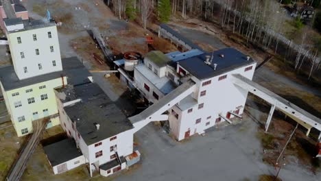 drone shot panning over an abandon ore mining facility in sweden