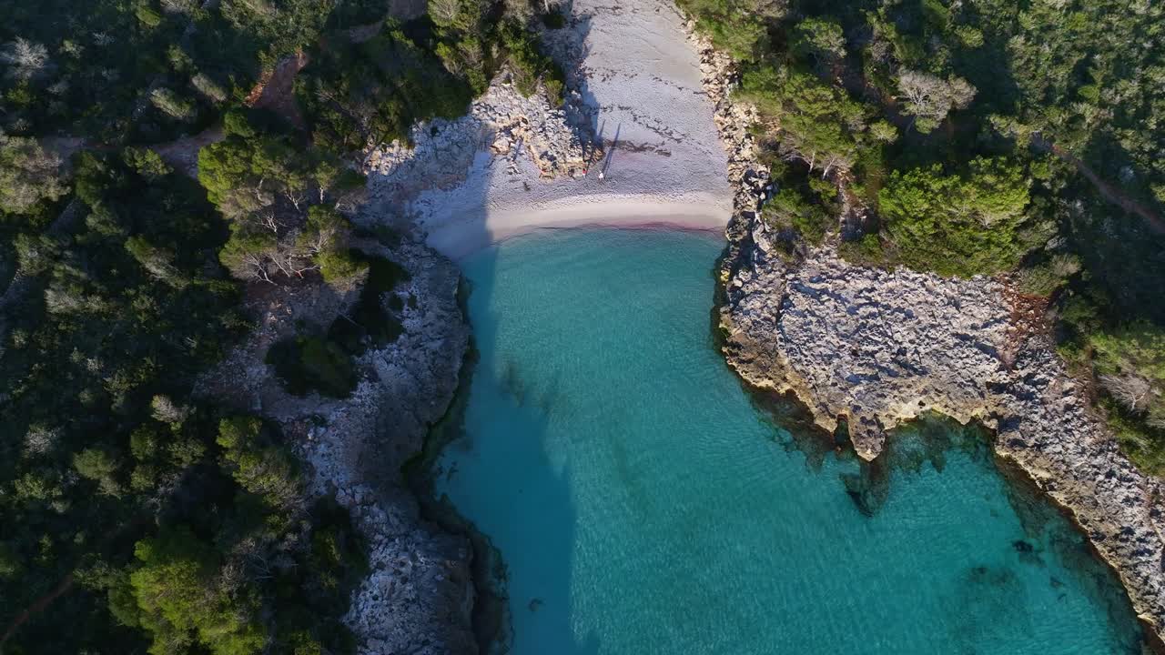 Aerial view of Es Talaier virgin Beach with clear blue water in Menorca Spain