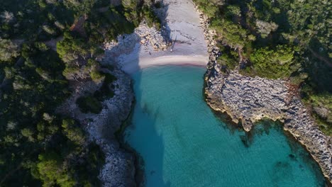 aerial view of es talaier virgin beach with clear blue water in menorca spain