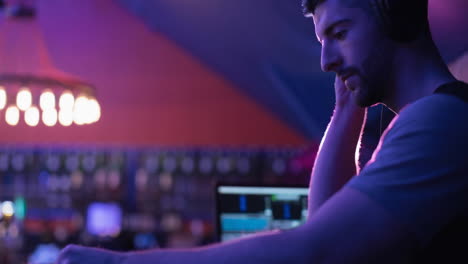 composition of caucasian male dj playing at disco