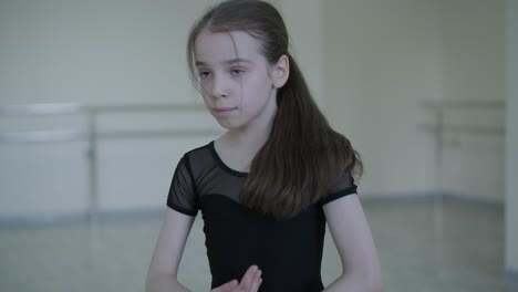 young ballerina practicing dance moves in studio