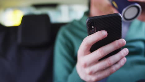 Albino-african-american-man-sitting-in-car-using-smartphone