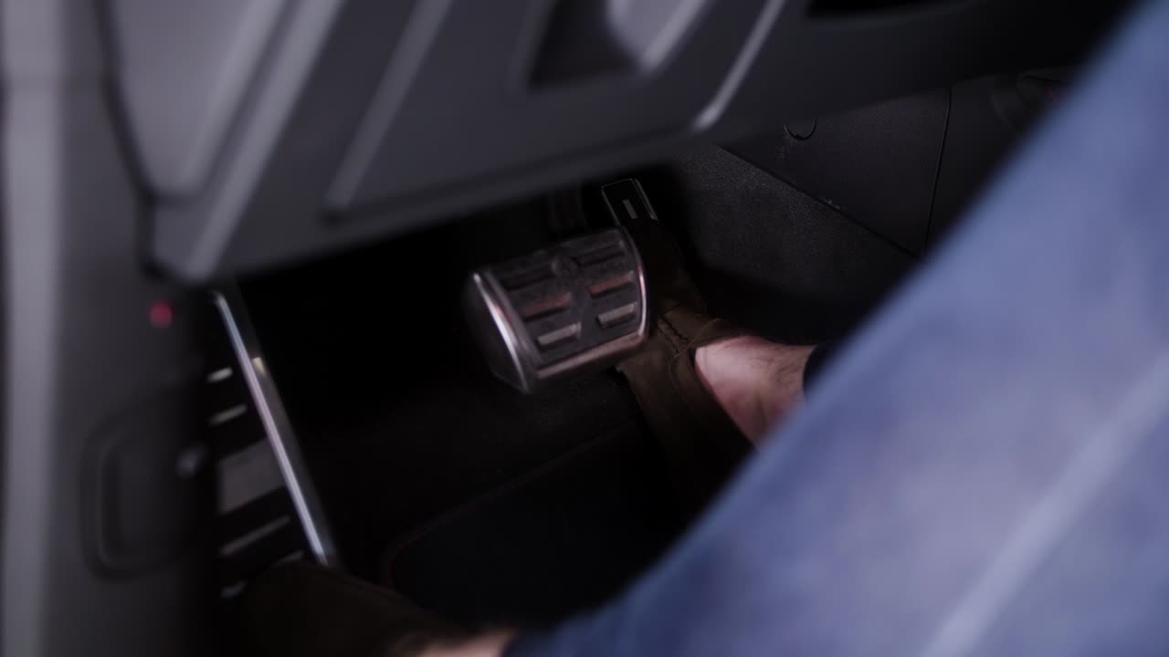 남자가 차를 운전하고 발로 가속한다