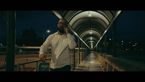 man walking at night on overpass