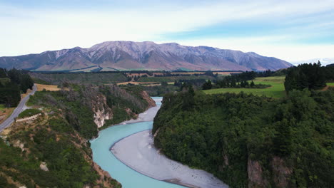 aerial ascending shot above the rakaia gorge river, sunny day in new zealand