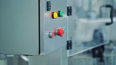 female starts the work of automated machine in a big modern plant. worker presses the colorful button of a robotic machine in a dairy factory.