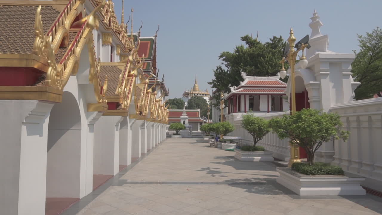Walking at a very popular tourist attraction and destination in the city of Bangkok in Thailand with golden mountain temple in the background