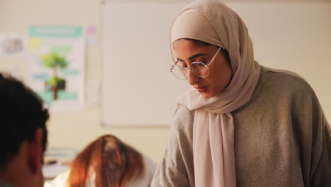 woman wearing a hijab in a classroom