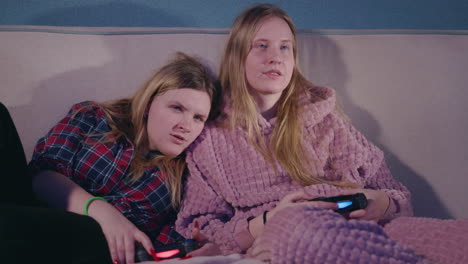 two friends gaming on the couch