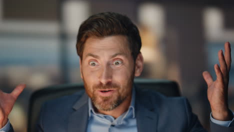 happy businessman rejoicing success working dark office closeup. man gesturing