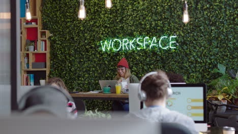 young caucasian woman student using laptop computer watching online entertainment smiling enjoying lunch break eating food in modern office