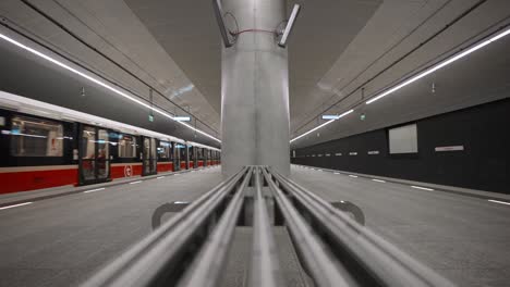 the train arrives at an empty metro station. szwedzka metro station. empty subway station.