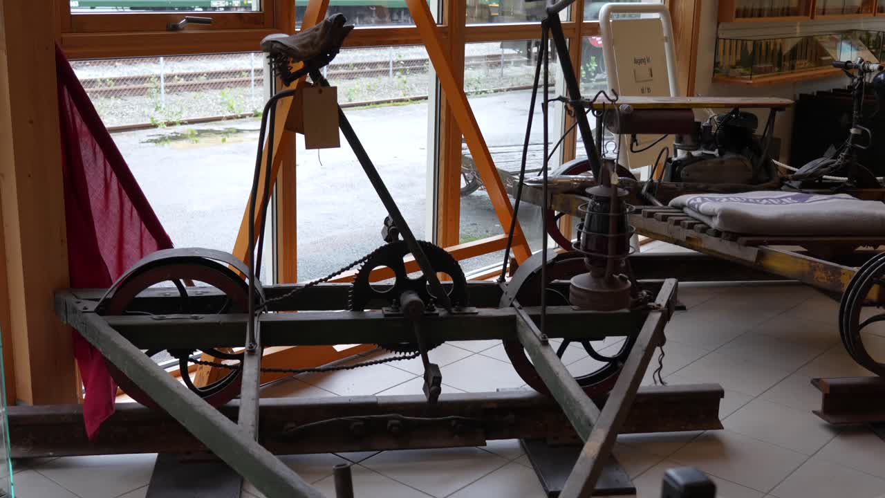 Camera pan across a vintage rail inspection draisine at Flåm Railway Museum, Norway, showcasing historical engineering and manual track maintenance design