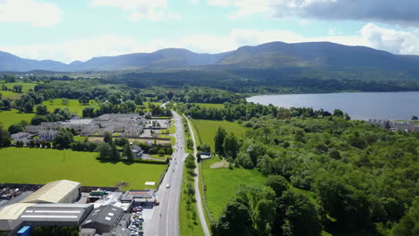 high altitude panning aerial video of motor bikers traveling along a beautiful journey, beside the lakes of killarney,along "the ring of kerry", ireland