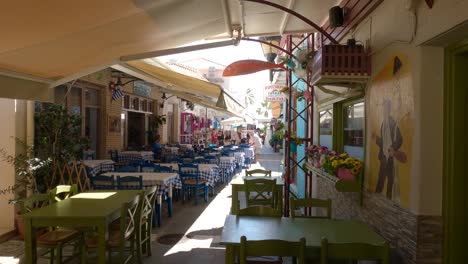 picturesque passage with tables, chairs and colored flowers