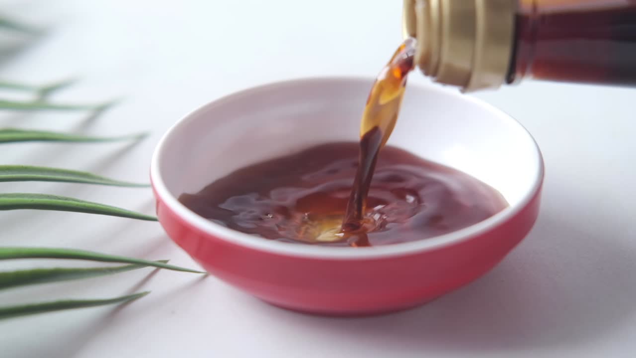 Soy Sauce Pouring into Small Bowl