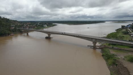 bridge infrastructure over alto beni river in rurrenabaque bolivia car traffic, aerial drone view