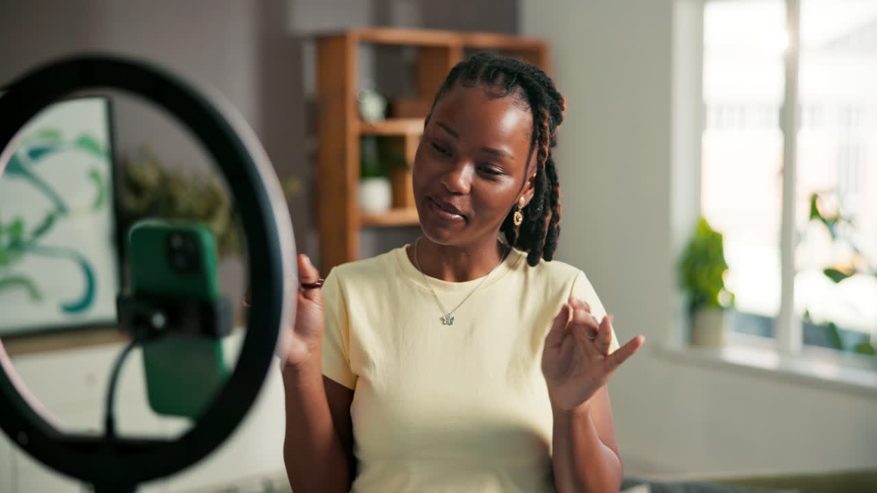 A woman filming a vlog with a ring light