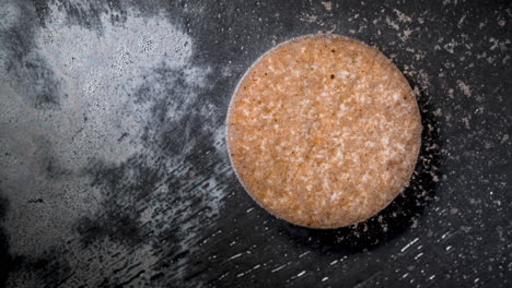 dissolving pill in water, timelapse shot showing granules dispersing